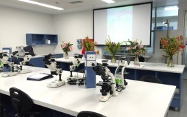 Microscopes and flowers on display inside the Biology labs