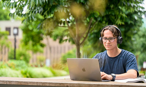 Male student on campus studying