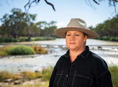 Sharon wearing a hat in an outdoor setting