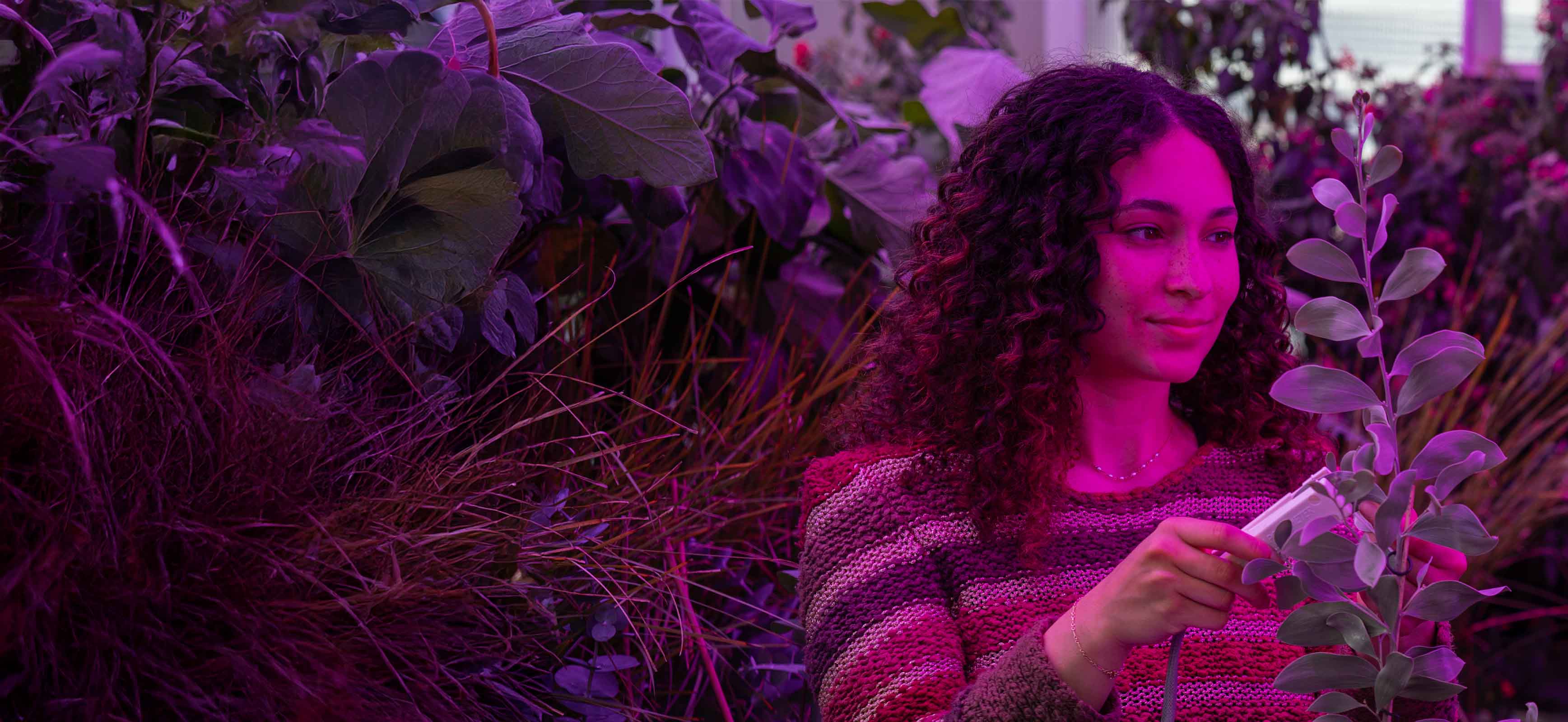 Female student looking at plants