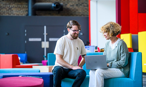 Student on campus discussing with lecturer