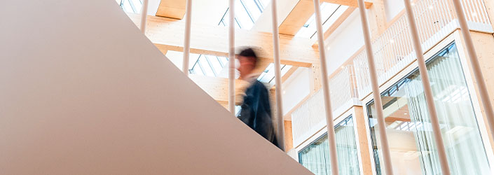 A blurred person walking up a set of stairs.