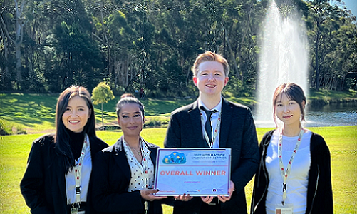 Team WoVi with their World Vision Challenge award in front of the Macquarie University lake