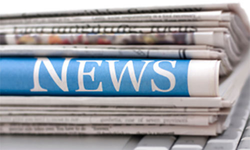 A stack of newspapers with NEWS written in large letters on one of them