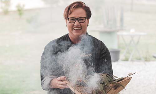 Sharon Winsor participating in a smoking ceremony