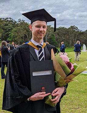 Richard Norrie in a graduation cap and gown.