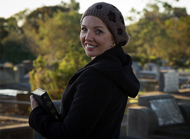 Rebecca Fraser wearing a beanie and smiling at the camera.