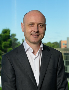 Professor Samuel Muller dressed in professional attire smiling at the camera.