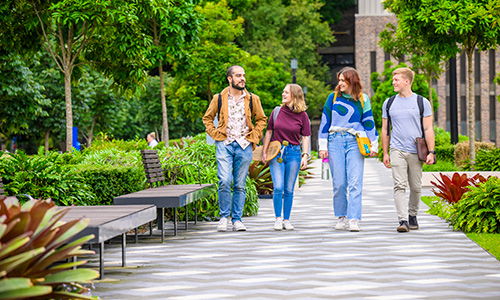 Students walking on campus laughing