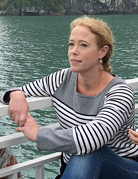 Linda Beaumont posing for a photo with a lake backdrop