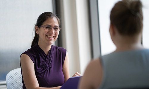 Two health professionals in conversation.