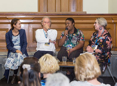 Rebecca Fraser as a speaker at a panel with three other people.