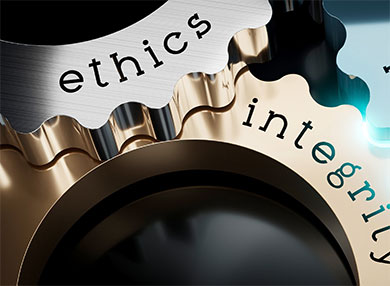 Close up of cogs of a wheel with the words 'ethics' and 'integrity' etched into them