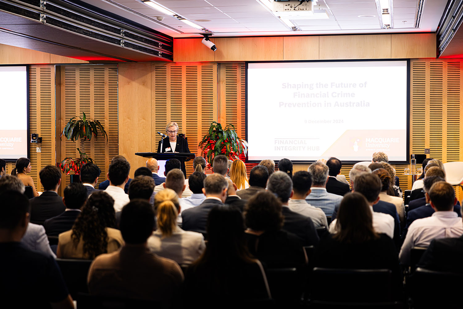 A large group of people looking at a presentation.