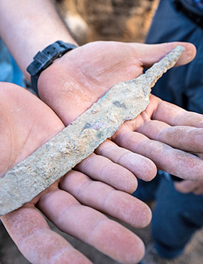 Ancient Israel artifact held in an archeologists hands