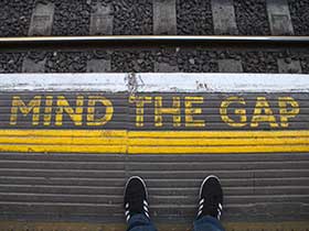 Mind the gap written on train platform
