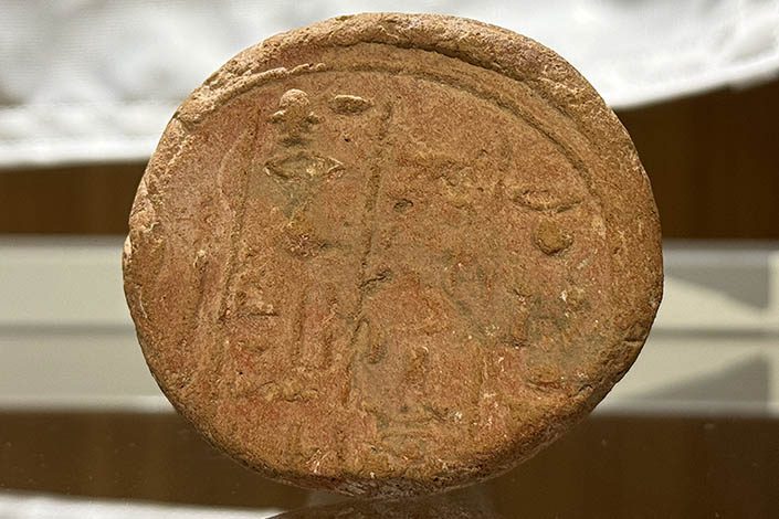 Ancient Egyptian funerary cone featuring hieroglyphs