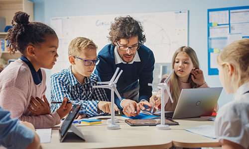 A teacher at a table with young children