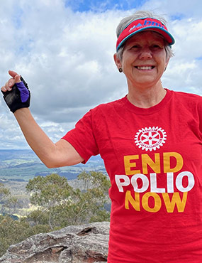 Jennifer Scott AM wearing a red t-shirt that reads: end polio now.