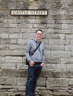 Hyun standing infront of Castle Street sign