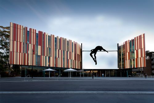 High jumper jumping over the library