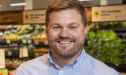 Adrian Cullen in front of supermarket shelves.