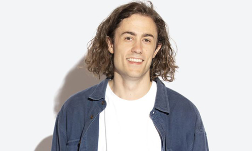 Bryce Mills smiling for a photo against a white background