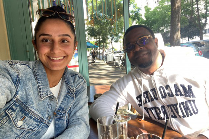 A selfie of Joya and Sylvestre Mang at a restaurant table