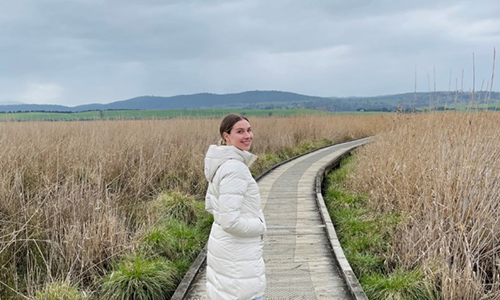 Madeleine out in an open grassy field in Tasmania