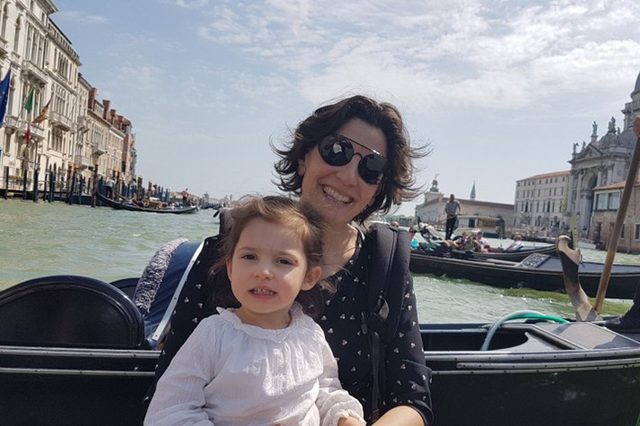 Zoe Flaherty on a boat holding a child