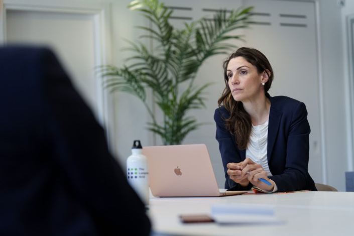 Zoe Flaherty sitting professionally at a table