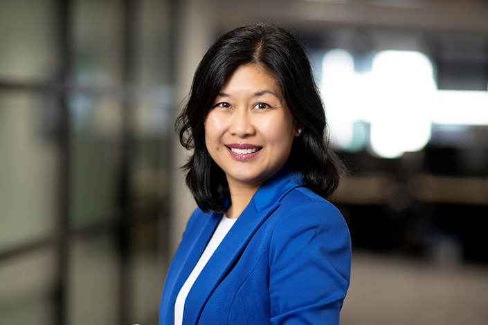 Kathrina Lo posing for a professional photo wearing a blue blazer