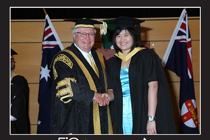 Valerie Teo graduation photo where she is shaking a mans hand